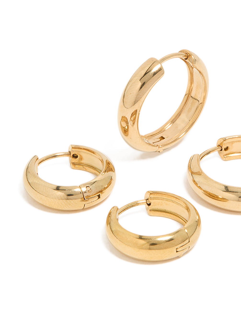 Designed with waterproof gold plated stainless steel, these thick huggie earrings in a 2-pack featuring chunky styling in a close up view
