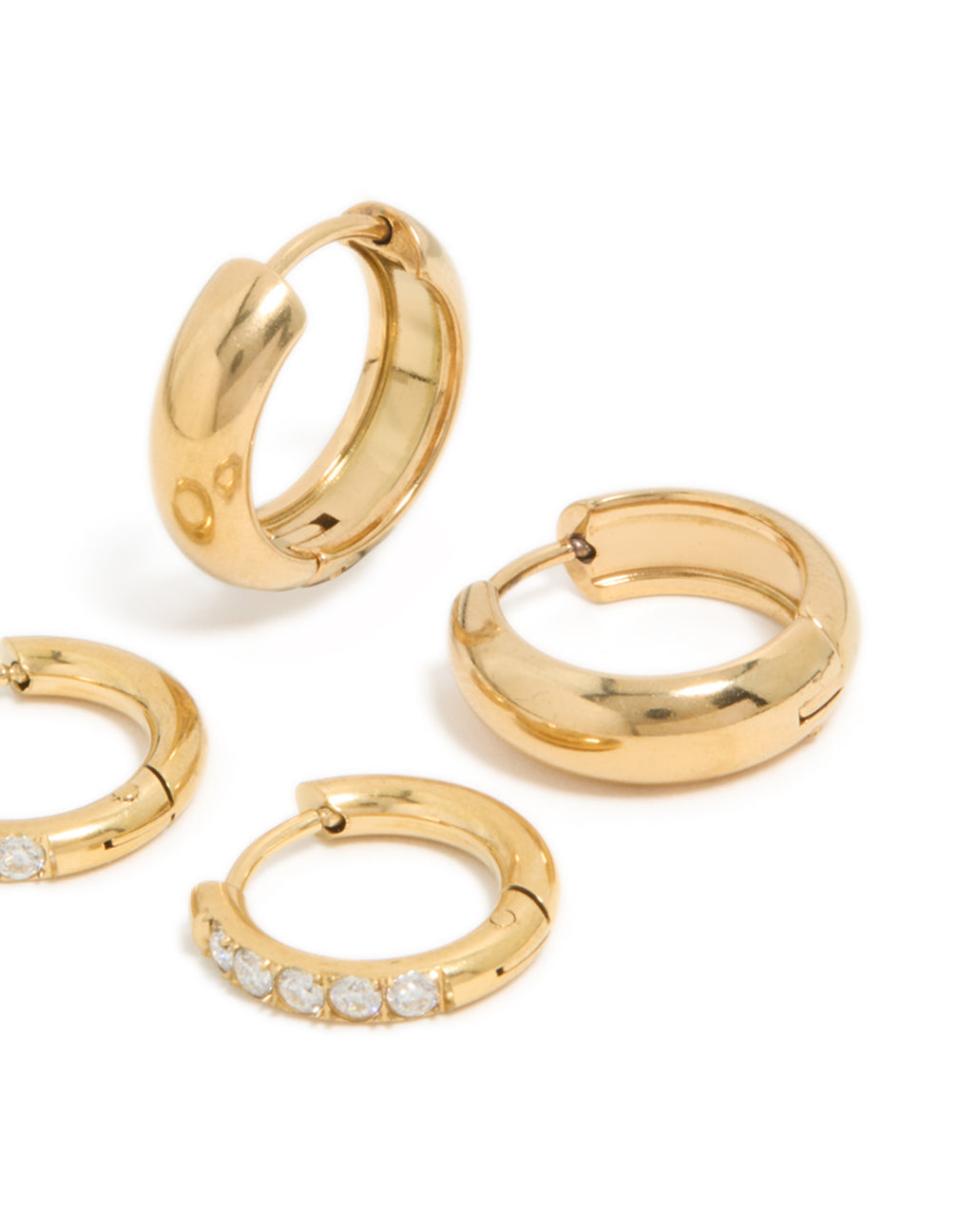 Detailed view of waterproof gold plated stainless steel cubic zirconia chubby huggie earrings in a 2-pack featuring chunky design with crystal accents in a post detail view