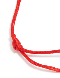 Highlighting a waterproof adjustable bracelet with gold plated stainless steel and red cord closure detail view - link has visual effect only