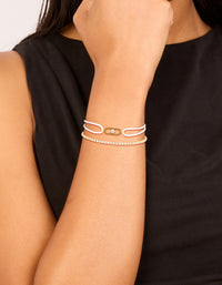 Stunning waterproof stainless steel bracelet set featuring gold plated tennis design with cubic zirconia and white cord on model view - link has visual effect only