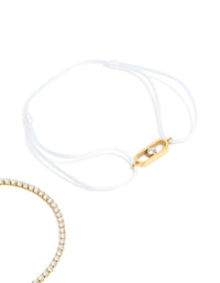 Beautiful waterproof gold plated stainless steel bracelet set with oval cut cubic zirconia tennis and white cord close up view - link has visual effect only