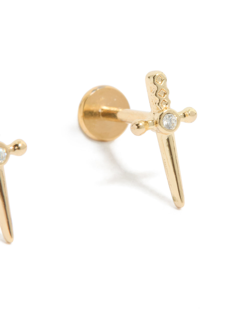 Highlighting the dagger-shaped stud with flat back closure, crafted from titanium in gold tone, adorned with a clear cubic zirconia centerpiece in a post detail view