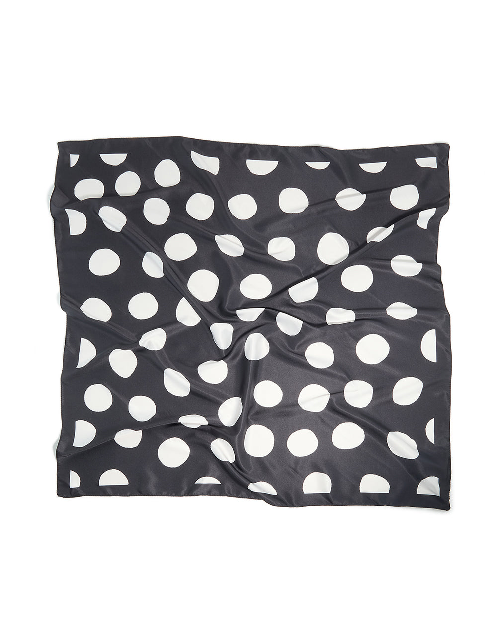 Showcasing a black and white statement polka dot fabric scarf front view