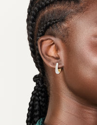 Showcasing mixed metal plated small cubic zirconia teardrop huggie earrings with hoop closure on ear view - link has visual effect only