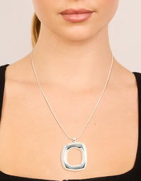 Showcasing a silver plated puffy square pendant necklace on neck view - link has visual effect only
