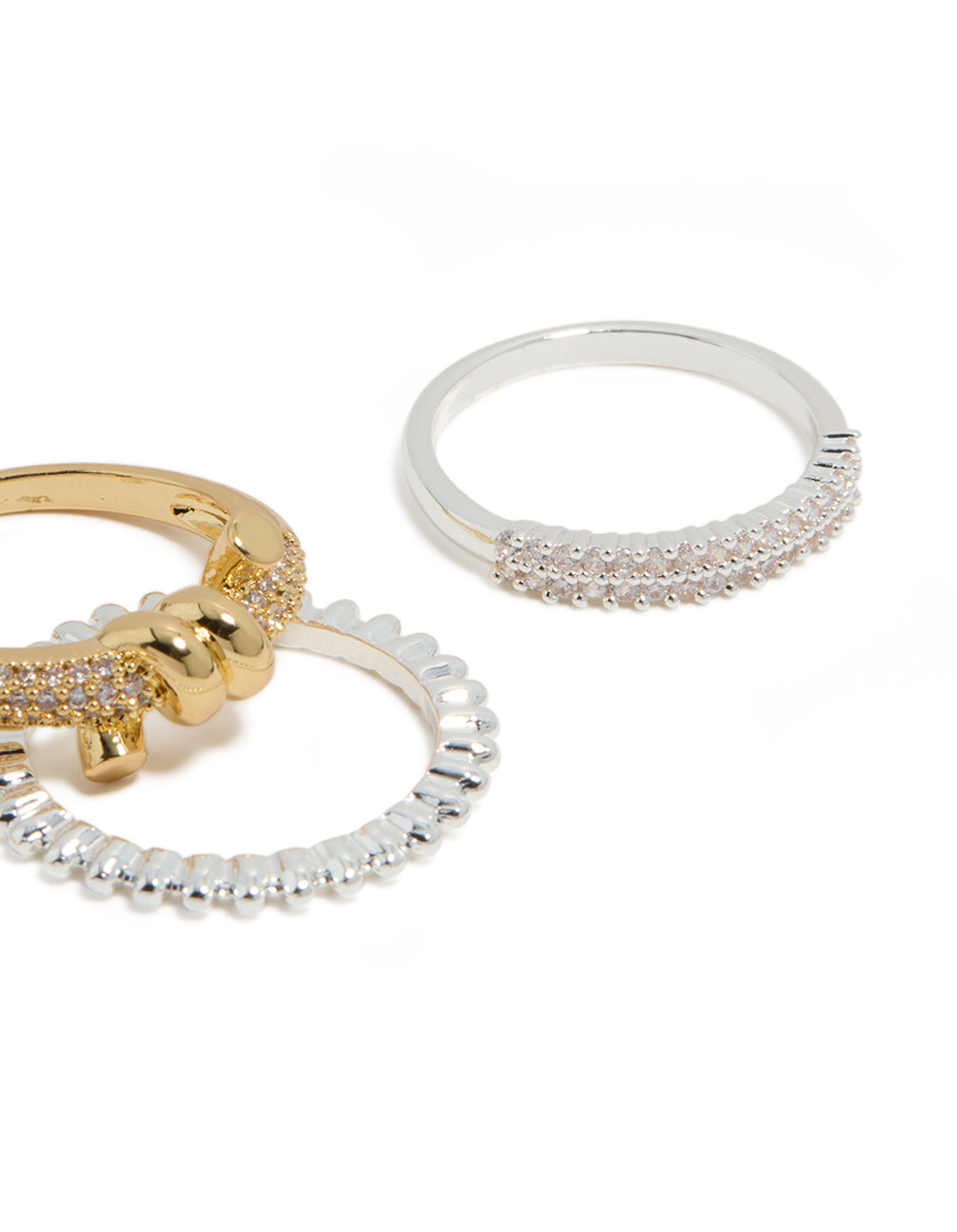 Featuring mixed metal plated cubic zirconia knotted textured rings 4-pack with beads and charm in gold, silver, clear and pink stone close up view