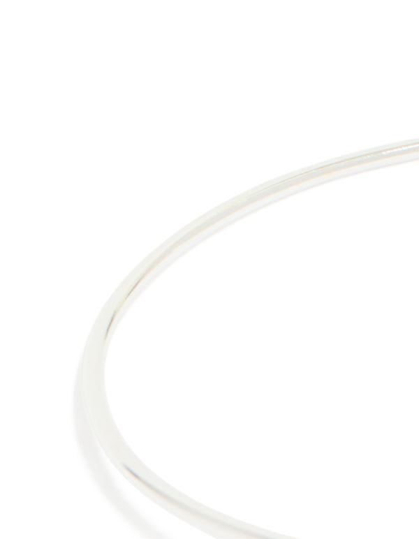 Explore a silver plated cubic zirconia floating wrap around bangle with statement style close up view