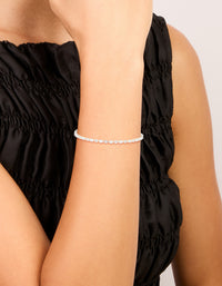 Crafted from silver plated cubic zirconia, this dainty oval tennis bracelet is shown in a stunning on wrist view - link has visual effect only