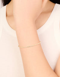Showcasing a dainty gold plated cubic zirconia mini tennis toggle bracelet on wrist view - link has visual effect only