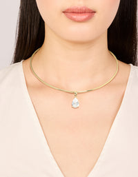 Showcasing a gold plated torque necklace with cubic zirconia teardrop pendant in dainty statement style on neck view - link has visual effect only