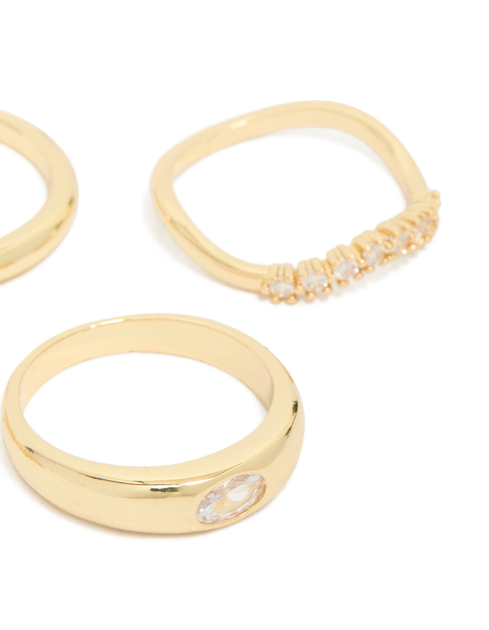 Highlighting gold plated cubic zirconia and plain rings 4-pack with crystal details in stackable chunky styling side detail view