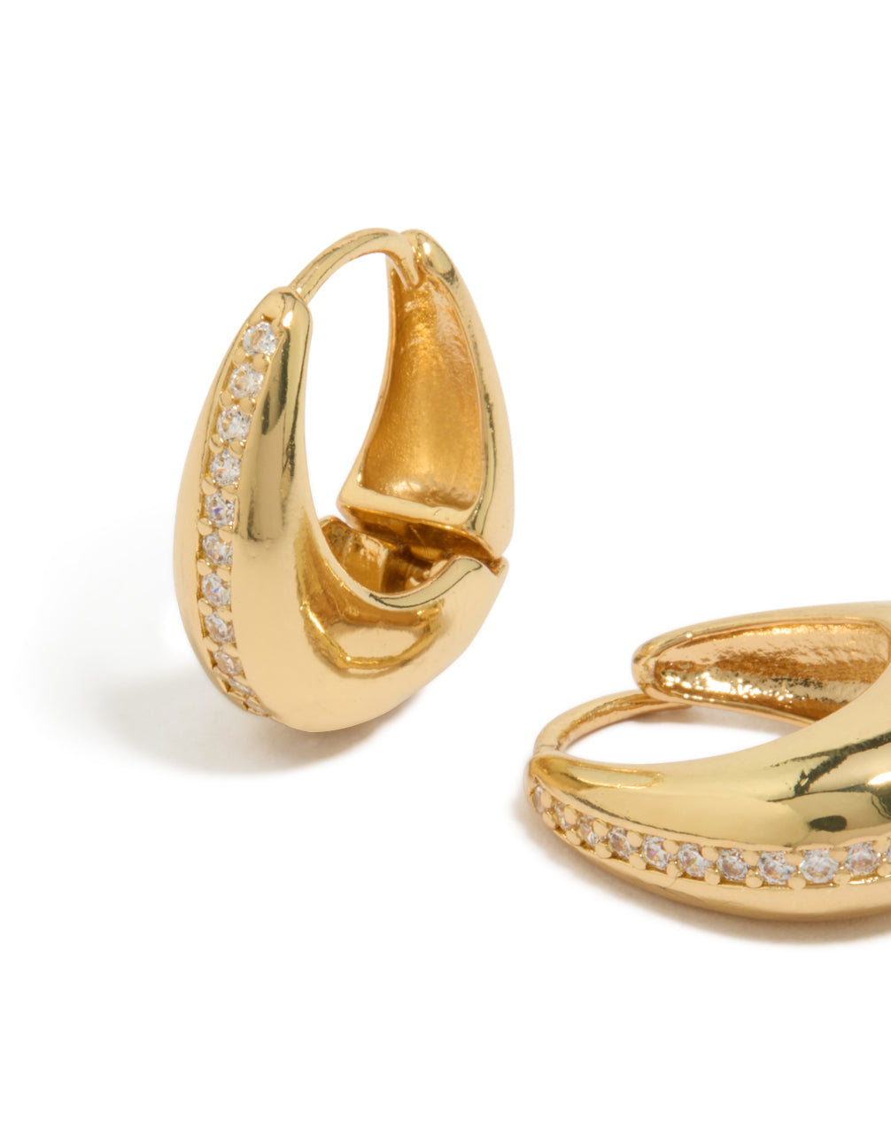 Detailed view of gold plated brass cubic zirconia teardrop huggie earrings highlighting craftsmanship close up view