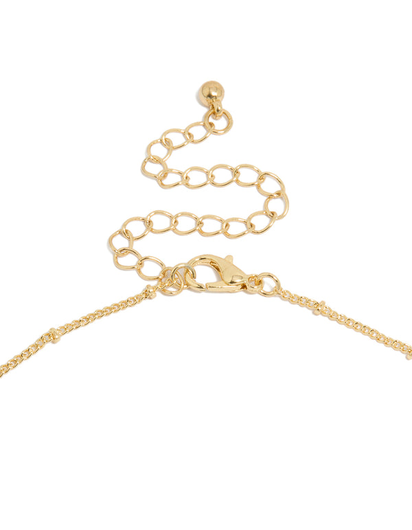 Displaying a gold plated brass necklace featuring evil eye charm with pearl pendant clasp detail view