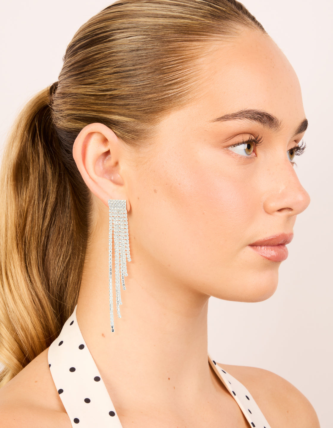Beautiful silver diamante waterfall drop earrings featuring tassel detailing on model view