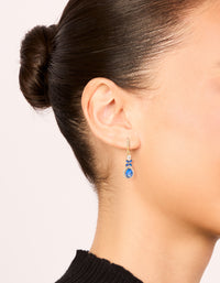 Showcasing gold blue cubic zirconia flower drop earrings featuring with crystal and statement style on ear view - link has visual effect only