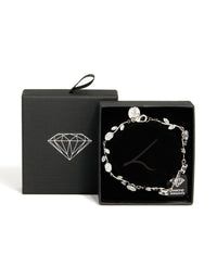 Detailed view of dainty vine bracelet featuring cubic zirconia stones in silver and clear with lobster clasp closure detail view - link has visual effect only