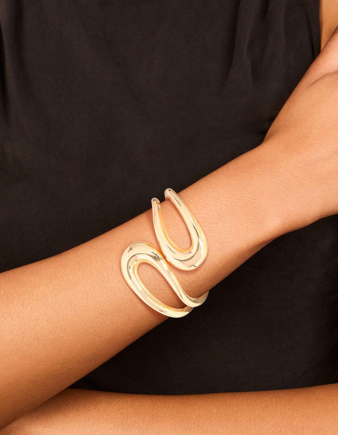 Showcasing a gold wrapped loop hinged bangle in a stunning on wrist view