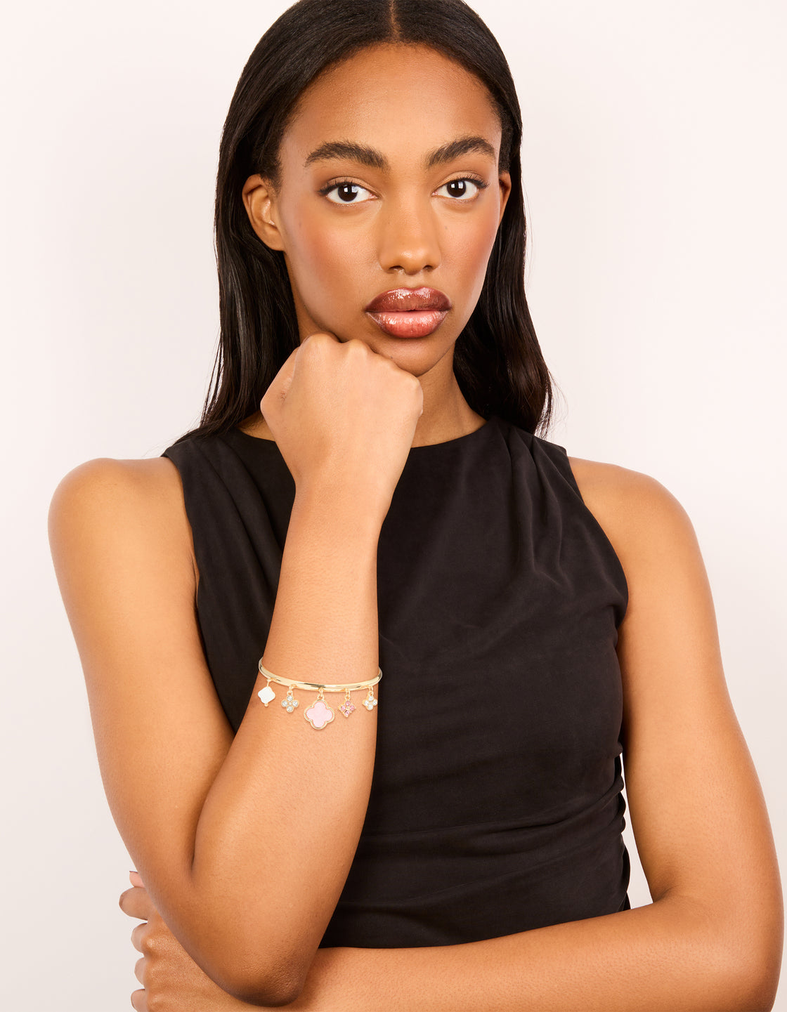 Displaying a gold pink flowers charm toggle bangle with floral statement styling on model view