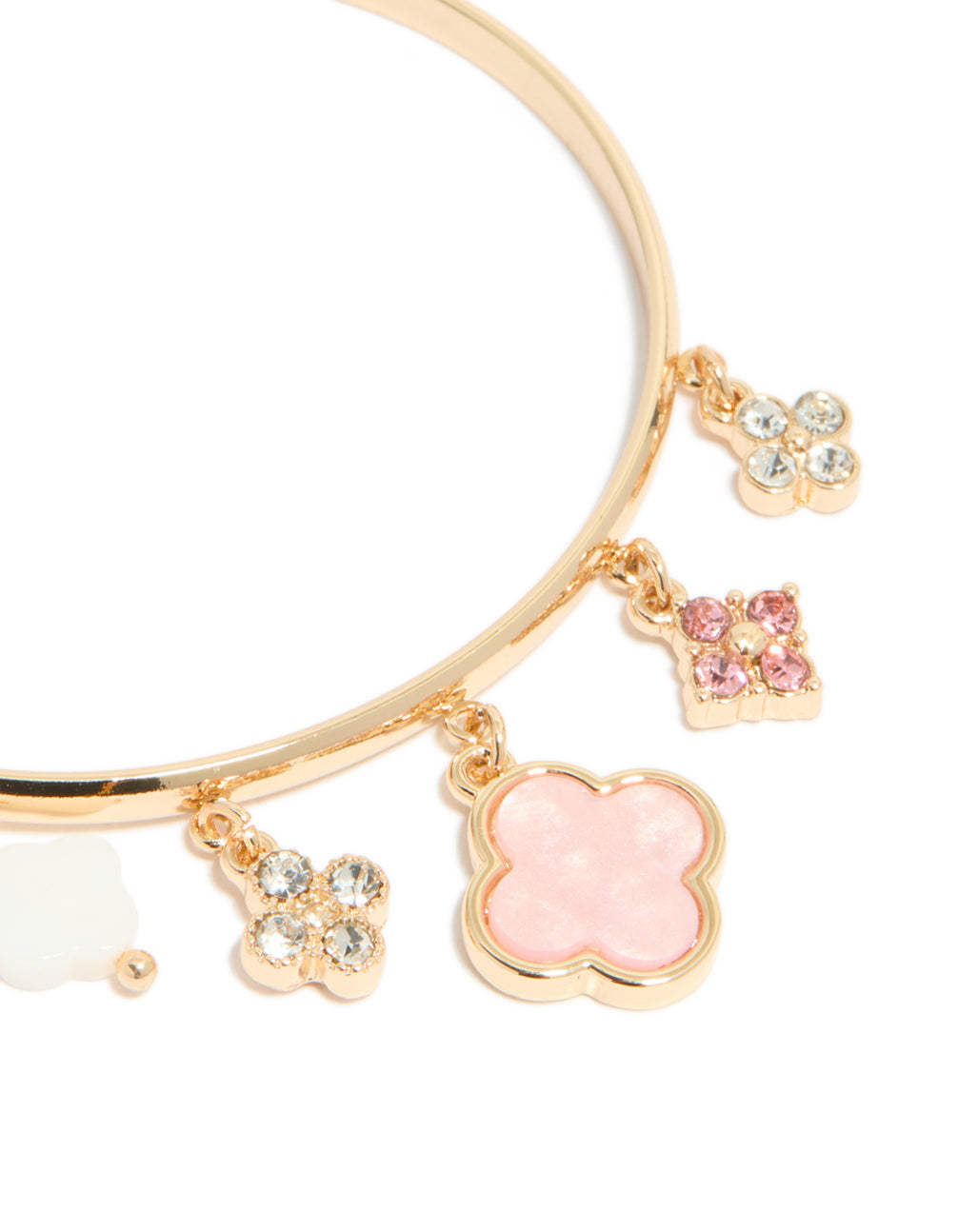Highlighting a gold pink flowers charm toggle bangle with floral quatrefoil charms and statement design close up view
