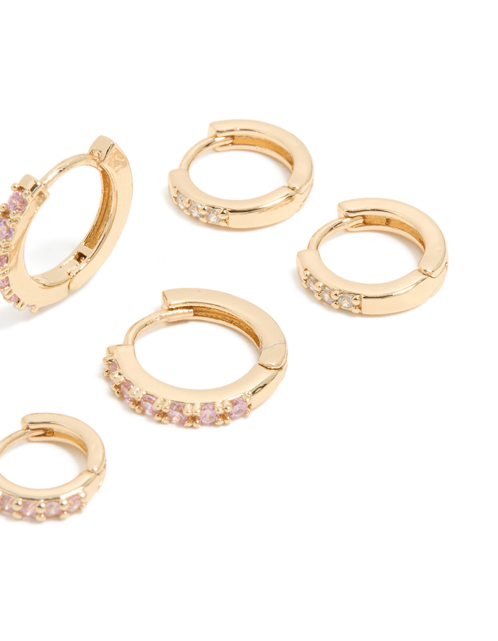 Highlighting gold light pink cubic zirconia simple huggie earrings in a 3-pack post detail view