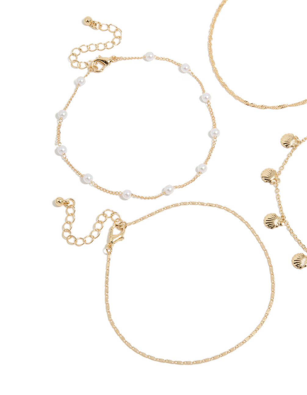 Crafted with ocean charm pearl and shell accents in gold anklets side view