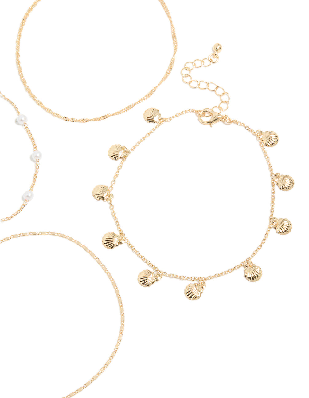 Featuring ocean charm with pearl and shell accents in gold anklets detail view