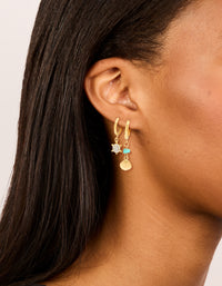 Crafted from waterproof gold plated stainless steel huggie earrings featuring shell turquoise ocean accents in a 2-pack on ear view - link has visual effect only