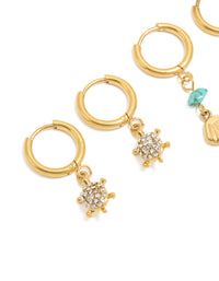 Designed with waterproof gold plated stainless steel huggie earrings featuring shell turquoise ocean accents in a 2-pack close up view - link has visual effect only