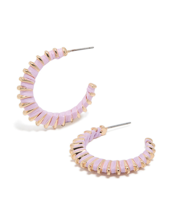 Featuring statement hoop earrings with textured gold and lilac enamel in a lavender color front view