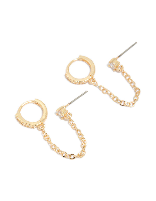 Showcasing statement gold diamante huggie and chain stud earrings front view