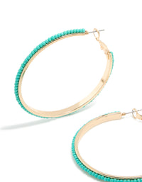 Crafted with large thin aqua beaded hoop earrings in turquoise and gold close up view - link has visual effect only