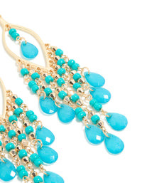Beautifully crafted gold blue beaded oval drop earrings featuring turquoise charms and fish hook closure post detail view - link has visual effect only