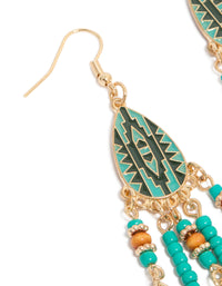 These blue feather and beaded drop earrings showcase leaf elements in teal, gold, dark turquoise, and peru hues, statement accessories close up view - link has visual effect only