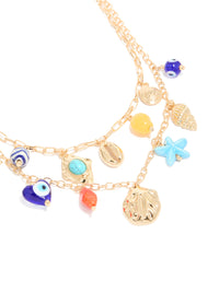 Beautifully crafted evil eye and sea charm layered necklace featuring beads, ocean-inspired shell designs, and turquoise accents in gold close up view - link has visual effect only