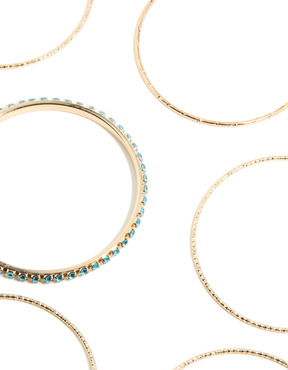 Featuring glitter bangles in gold with turquoise accents close up view