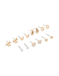 Featuring mini stud earrings in a 7-pack with bow, celestial star, ball, heart, and pearl designs in gold front view - link has visual effect only