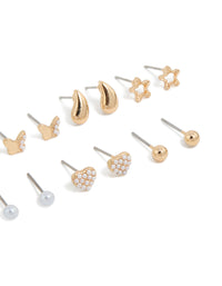 Designed with mini stud earrings featuring bow, celestial star, ball, heart, and pearl accents in gold 7-pack post detail view - link has visual effect only