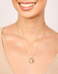 Beautifully crafted mixed metal small swirl pendant necklace featuring in gold and silver plated finishes on neck view - link has visual effect only