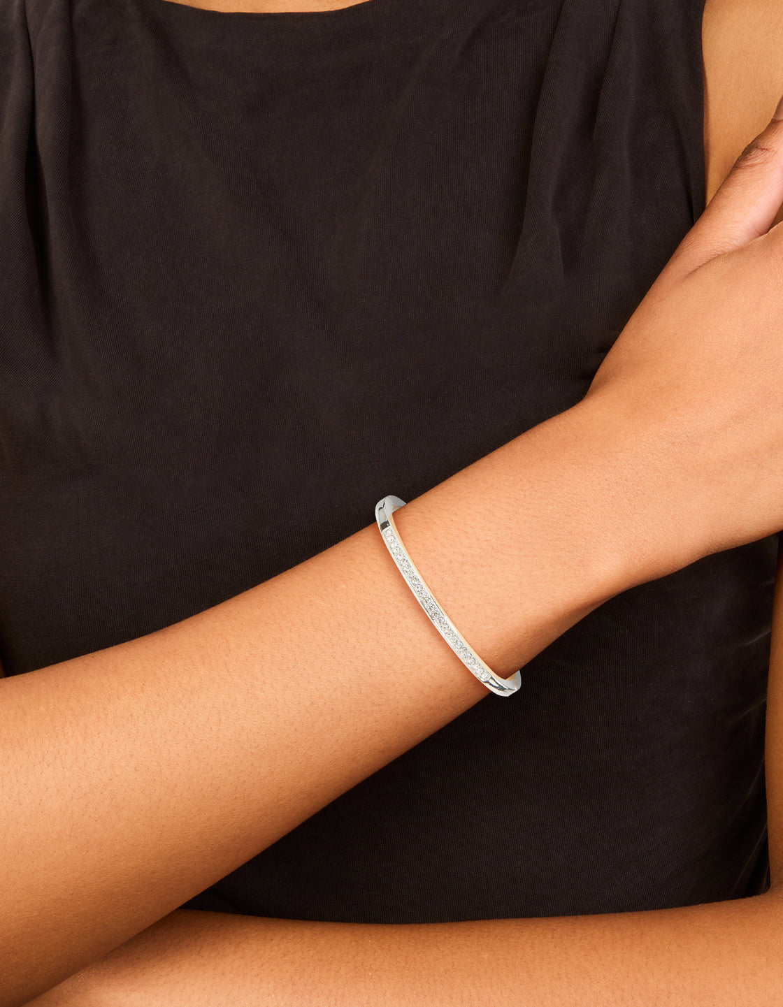 Showcasing a silver plated bezel diamante tennis bracelet on wrist view