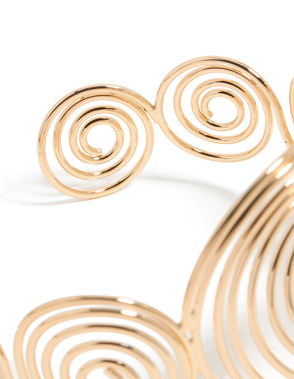 Crafted in gold, this multi swirl arm cuff bangle showcases statement styling closure detail view