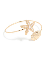 Featuring a gold shell and pearl starfish arm cuff with ocean-inspired front view - link has visual effect only