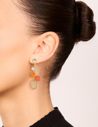 Crafted from gold beaded hoop and drop earrings 3-pack featuring charms with hoop closure in orange, tan, and coral tones on ear view - link has visual effect only