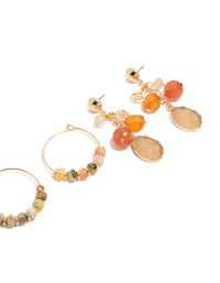 Featuring gold beaded hoop and drop earrings 3-pack with charms in hoop closure, showcasing orange, tan, and coral details post detail view - link has visual effect only