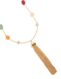 Beautifully crafted beaded, tassel statement necklace in gold with multicoloured drop design close up view - link has visual effect only