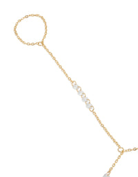 Showcasing gold plated floating cubic zirconia hand chain bracelet with featuring beads close up view - link has visual effect only