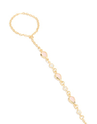 Crafted from gold plated material, this pink cubic zirconia teardrop hand chain bracelet in statement design close up view - link has visual effect only