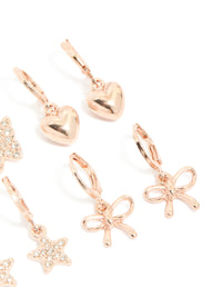 Crafted with kids rose gold diamante pavé huggie earrings in a 4-pack showcasing bow, celestial, heart, and butterfly accents post detail view - link has visual effect only