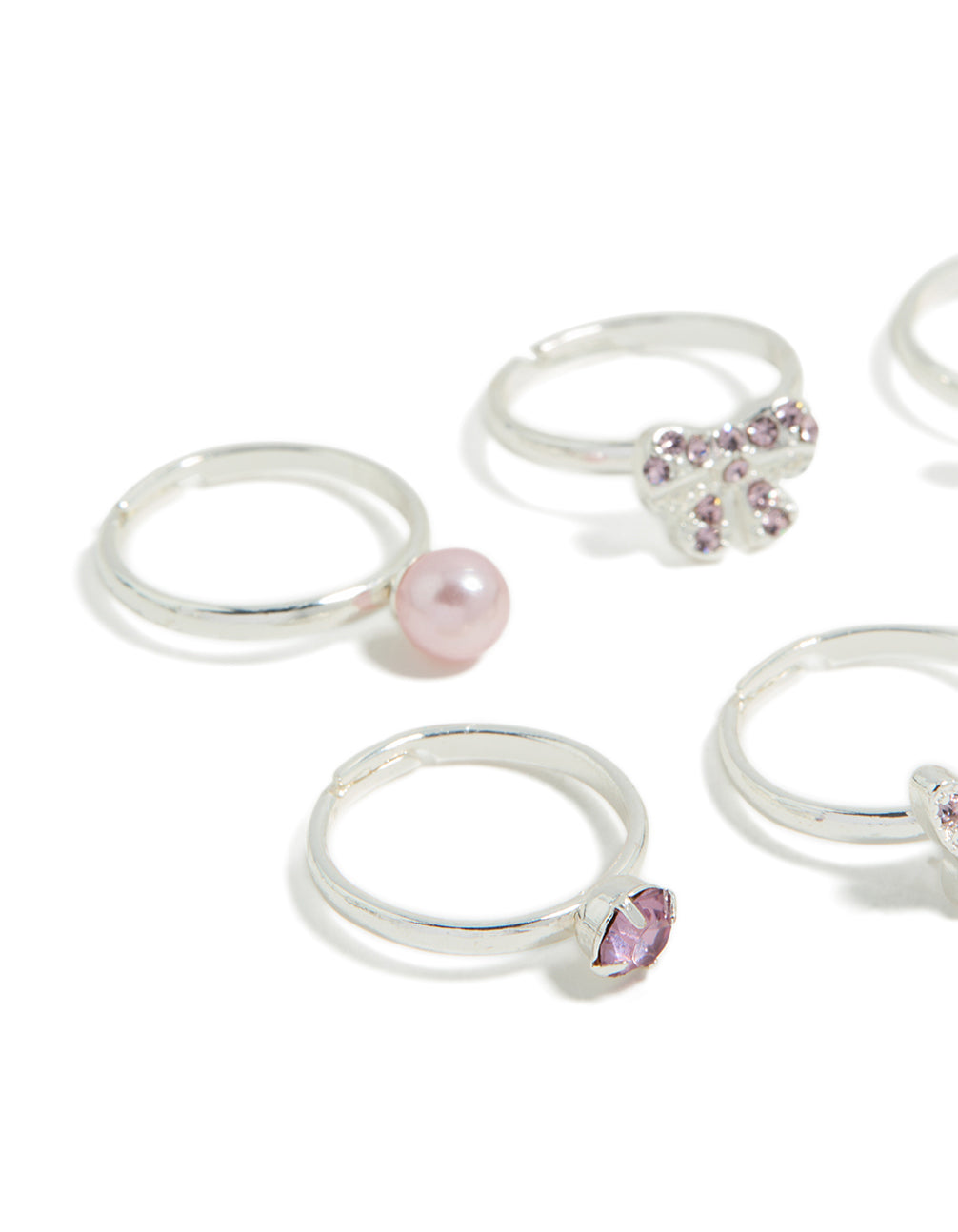 Crafted from silver, kids diamante bow, pearl and butterfly rings in pink and plum close up view