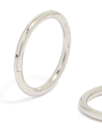 Featuring surgical steel 8 mm thick sleeper hoop earrings in silver with chunky styling close up view - link has visual effect only