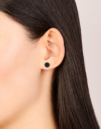 Featuring black coated surgical steel disc flat back studs in minimalist design on ear view - link has visual effect only
